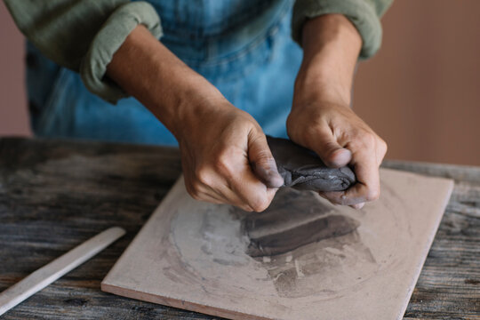 Young woman modeling clay