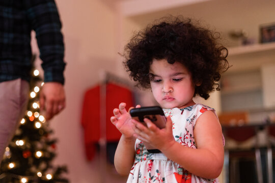 little toddler girl using an android cellphone