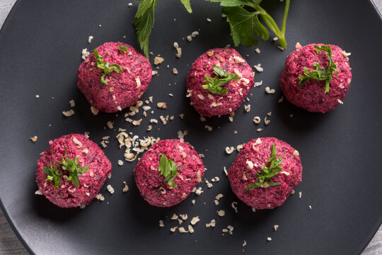 Georgian beetroot phali or pkhali with walnuts, garlic and spices on black plate
