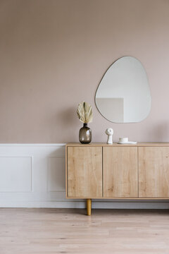 Wooden cabinet with decorative items in modern room