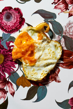deformed fried egg on a floral background