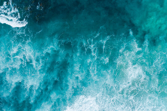 Aerial views over crashing sea waves on rocking ocean crop