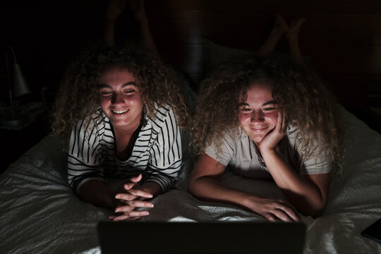 Twin sisters watching a movie