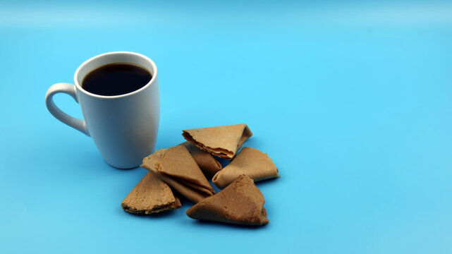 Cup of coffee and Kuih Sepit or Love letter cookies, a traditional wafer snack