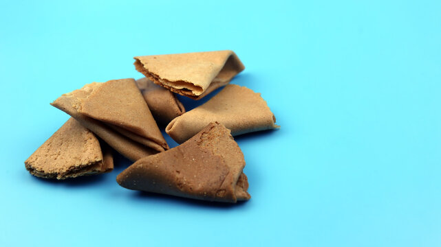 Kuih Sepit or Love letter cookies is traditional wafer snack made by clasping egg batter using an iron mold which is heated up on a charcoal stove. Selective focus