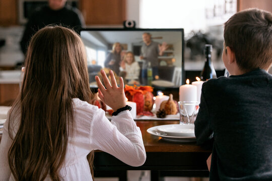 Thanksgiving: Girl Waves To Distanced Relatives On Monitor