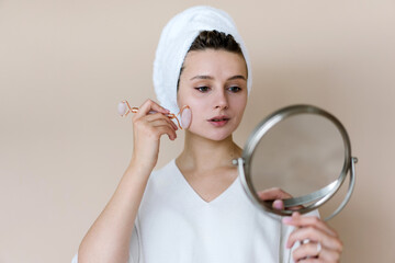 Woman doing facial Gua Sha massage