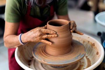 Woman Making Pottery On Spinning Wheel