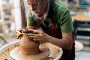 Woman Making Pottery On Spinning Wheel