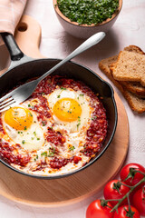 Traditional israel food eggs with tomatoes shakshouka in a pan