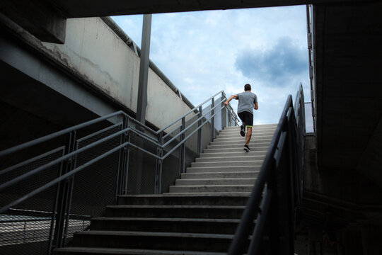 Male runner climbing up the stairs