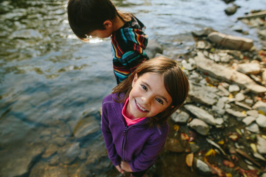 kids hugging and milking in nature