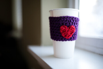 Cup with crocheted heart cozy