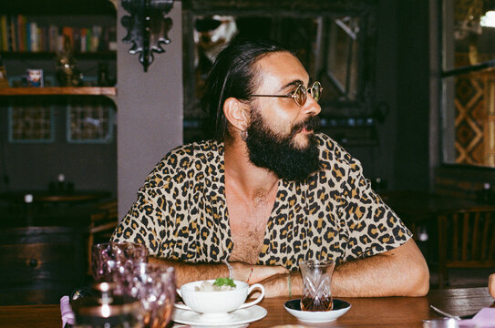 Man in a leopard shirt at the dinner table