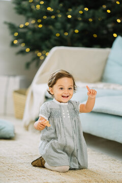 Happy little girl near the Christmas Tree