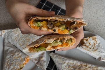 person holding a sandwich with falafel