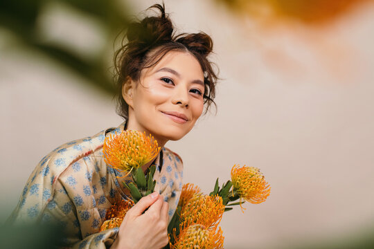 Happy woman with blooming flowers