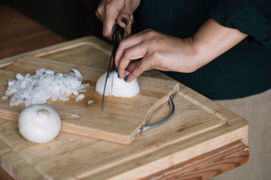 Anonymous Woman Cutting Fresh Onion For Handmade Dolmadakia