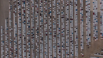 Large car parking in front of a car factory - grid filled with cars