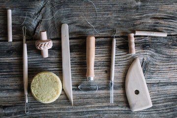 Clay modeling tools on wooden table