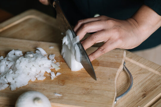 Anonymous Woman Cutting Fresh Onion For Handmade Dolmadakia