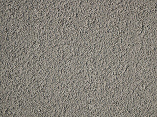 Detail of bumpy concrete wall painted in gray color