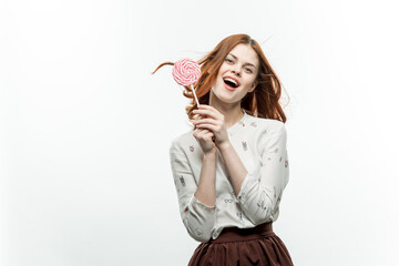 pretty woman with round lollipop near face fun sweets