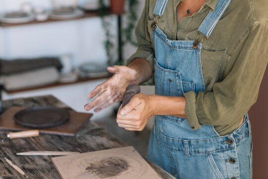 Young woman modeling clay