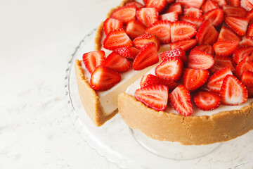 Tasty cheesecake with strawberry on white background, closeup