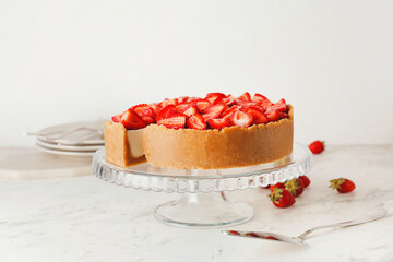 Tasty cheesecake with strawberry on white background