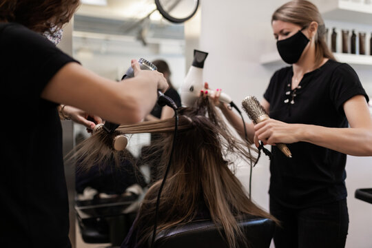 hairdressers combing a client