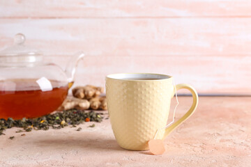 Cup of aromatic black tea on color background