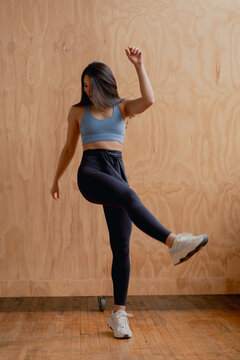 Athletic Woman Kicking Her Leg Up