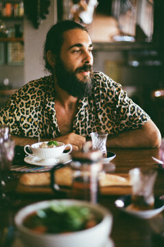 Man in a leopard shirt at the dinner table