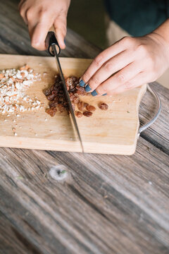 Anonymous Woman Cutting Almonds For Handmade Dolmadakia