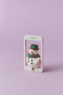 Handcraft plasticine Snowman figure in a tablet frame.