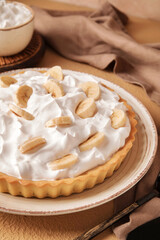 Plate with tasty banana pie on table