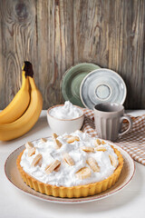 Plate with tasty banana pie on table