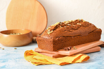 Boards with tasty gingerbread cake on color background