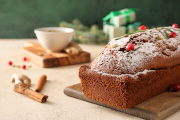 Board with tasty gingerbread cake on light background