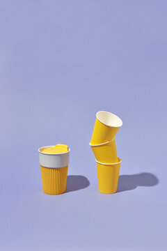 Stack of paper disposable cups and one reusable mug.