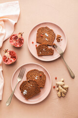 Plates with pieces of gingerbread cake on color background