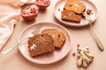 Plates with pieces of gingerbread cake on color background