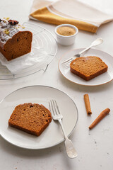 Plates with pieces of gingerbread cake on light background