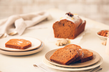 Plate with pieces of gingerbread cake on table