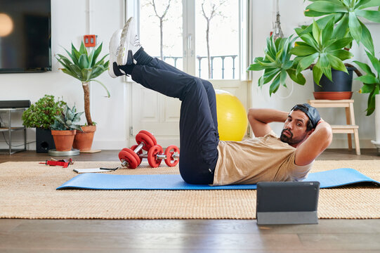 Fit young man doing a video workout