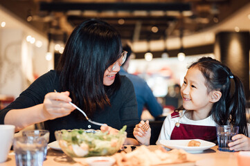 Mom and kid eating in the restaurant