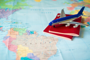toy aircraft with two passports on the map, travel concept, flight to south america, trip by plane