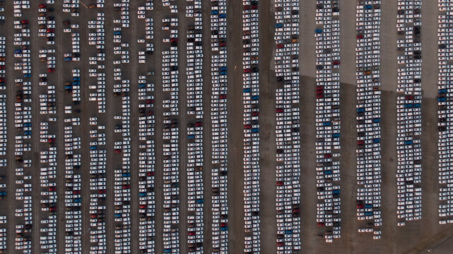 Large car parking in front of a car factory - grid filled with cars