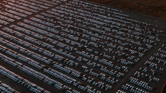 Large car parking in front of a car factory - grid filled with cars